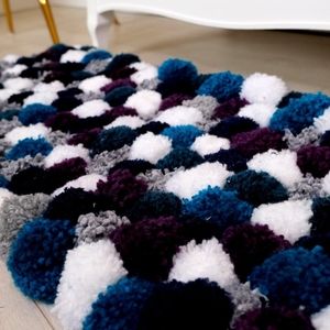 Pom pom area rug